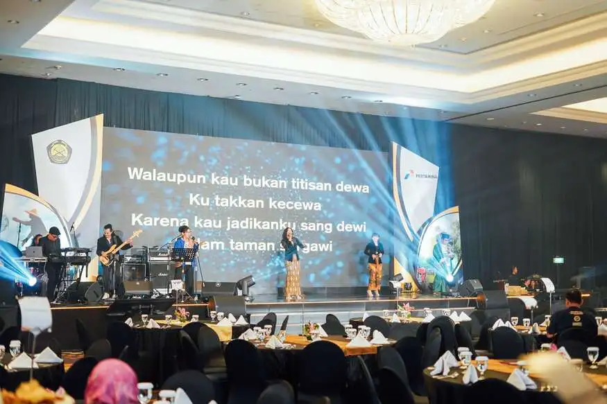 A ballroom event with a live band and seated guests